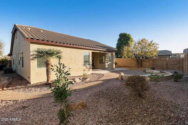 back of house with central AC unit and a patio area