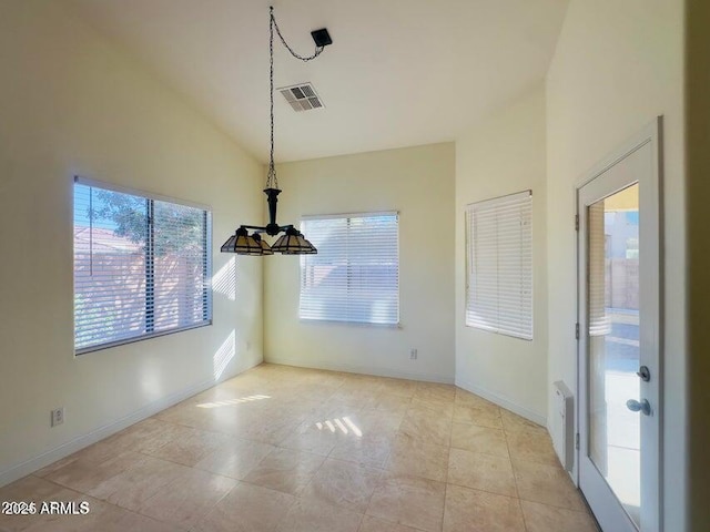 unfurnished dining area featuring vaulted ceiling and light tile patterned floors