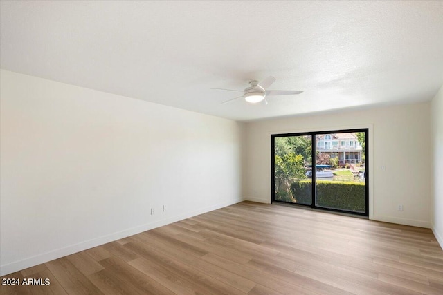 empty room featuring ceiling fan and light wood-type flooring