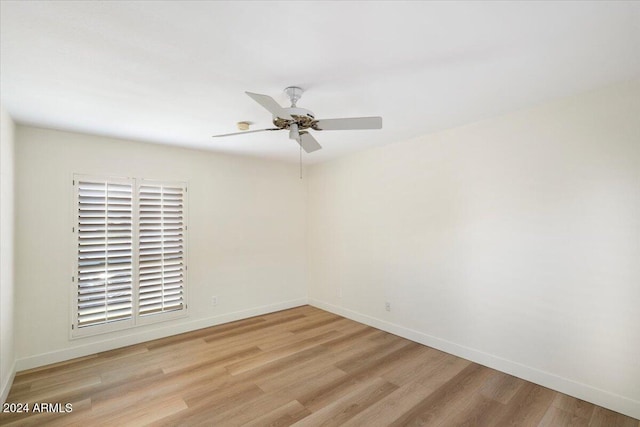 spare room featuring light hardwood / wood-style flooring and ceiling fan