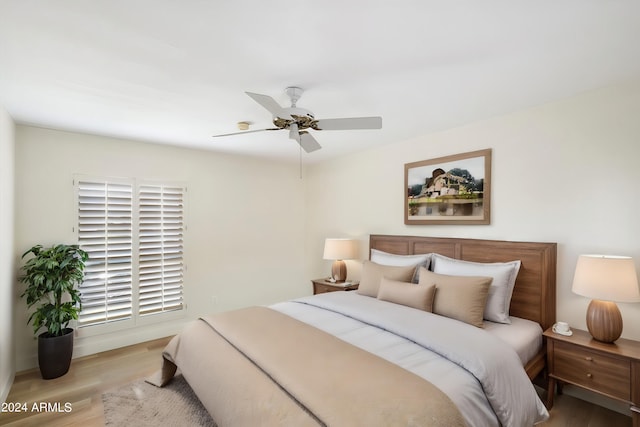 bedroom with ceiling fan and light wood-type flooring