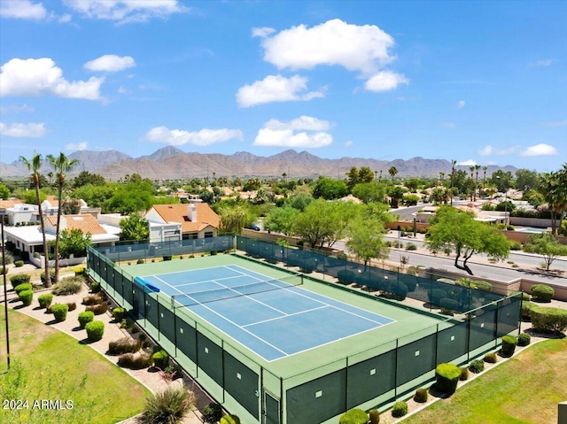 view of tennis court featuring a mountain view