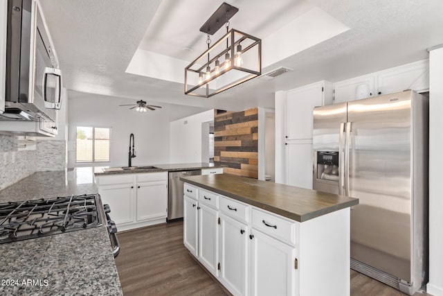 kitchen with white cabinetry, appliances with stainless steel finishes, tasteful backsplash, and sink