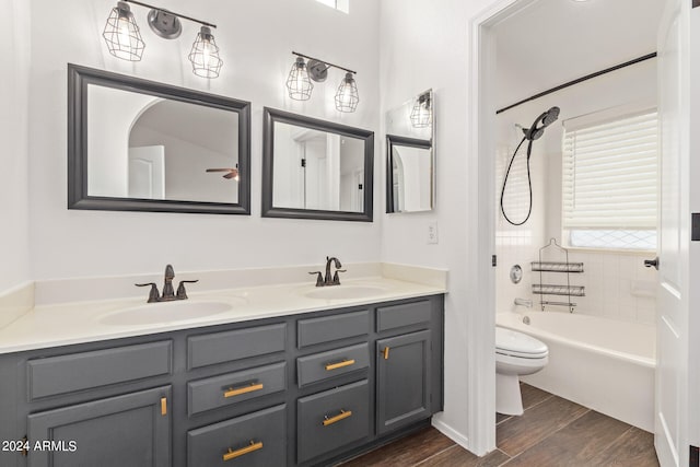 full bathroom featuring vanity, shower / bath combination, hardwood / wood-style floors, and toilet