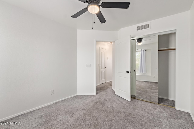 unfurnished bedroom featuring carpet, ceiling fan, and a closet