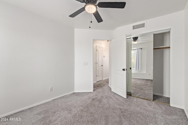 unfurnished bedroom with visible vents, carpet flooring, baseboards, and a closet