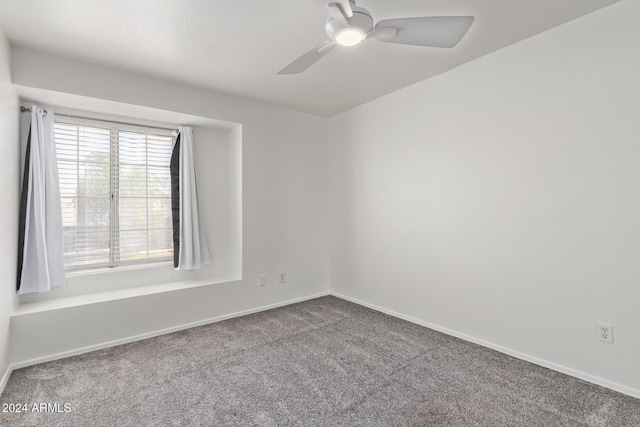 unfurnished room with baseboards, ceiling fan, and carpet