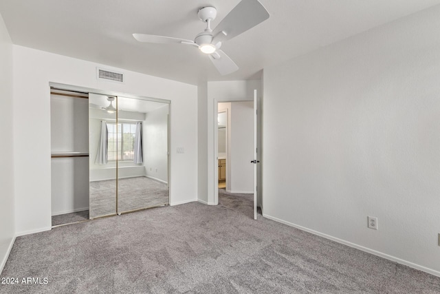 unfurnished bedroom with visible vents, carpet floors, a closet, baseboards, and ceiling fan