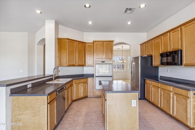 kitchen with sink, kitchen peninsula, light tile patterned floors, and black appliances