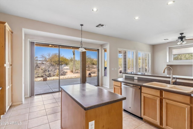 kitchen featuring decorative light fixtures, an island with sink, sink, stainless steel dishwasher, and a healthy amount of sunlight