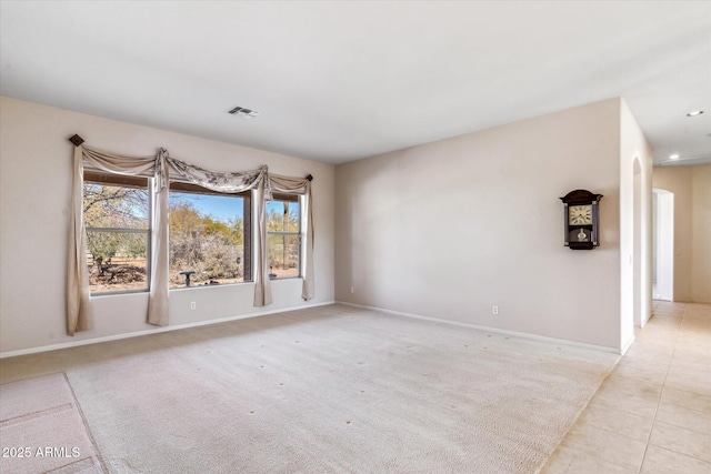 spare room featuring light carpet