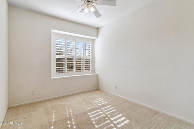 empty room featuring light carpet and ceiling fan