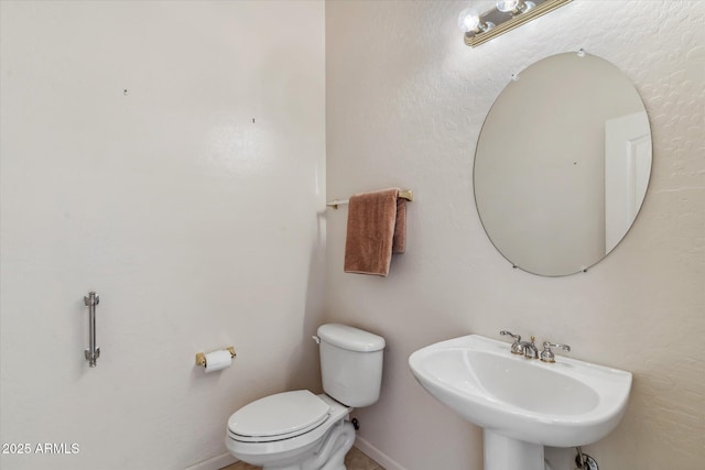 bathroom with toilet and sink