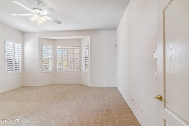 carpeted empty room with ceiling fan