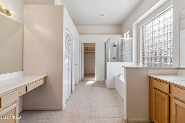 bathroom with vanity, tile patterned flooring, and shower with separate bathtub