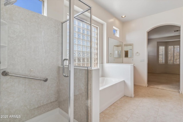 bathroom with shower with separate bathtub and tile patterned floors