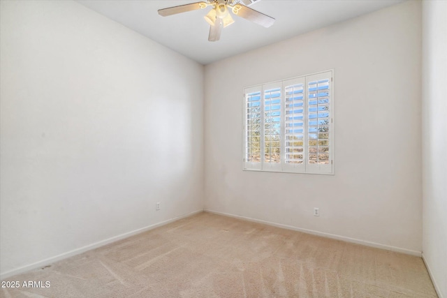 unfurnished room with light colored carpet and ceiling fan