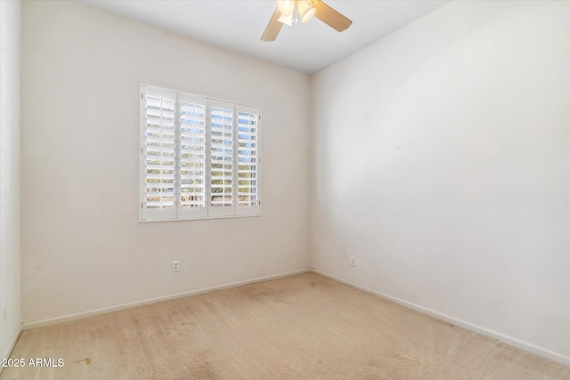 unfurnished room with light colored carpet and ceiling fan