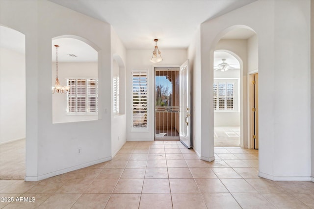 tiled foyer entrance with ceiling fan