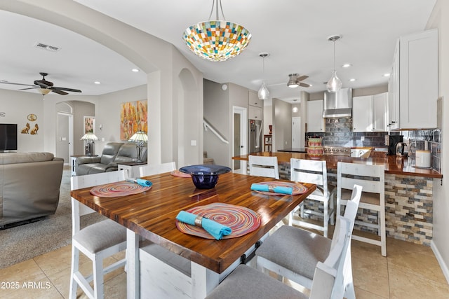 dining area featuring recessed lighting, arched walkways, light tile patterned flooring, and ceiling fan