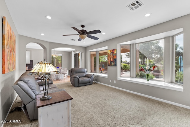 carpeted living area featuring visible vents, ceiling fan, recessed lighting, and arched walkways
