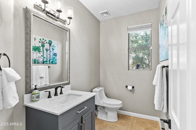 bathroom with visible vents, baseboards, toilet, vanity, and tile patterned flooring