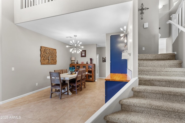 stairs with baseboards, an inviting chandelier, and tile patterned flooring