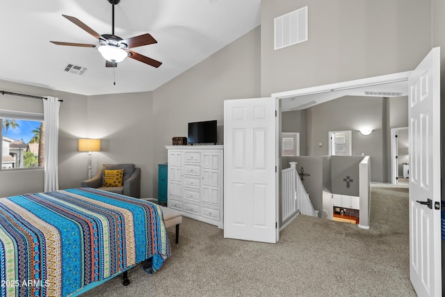 bedroom featuring carpet, visible vents, vaulted ceiling, and ceiling fan