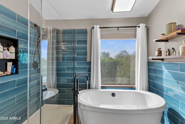 full bath featuring tile walls, a shower stall, and a soaking tub