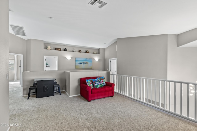 living area featuring visible vents, carpet, and lofted ceiling