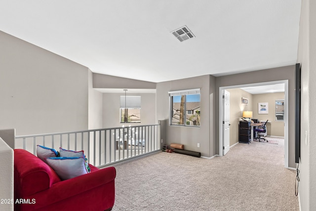living area with carpet flooring, visible vents, and baseboards