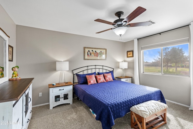 carpeted bedroom with ceiling fan and baseboards