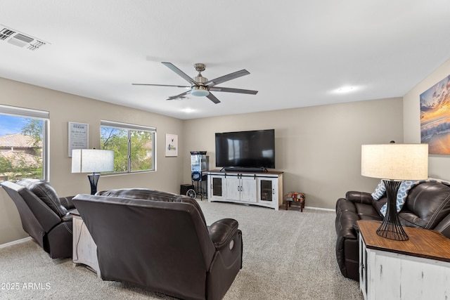 living room with ceiling fan, light colored carpet, baseboards, and visible vents