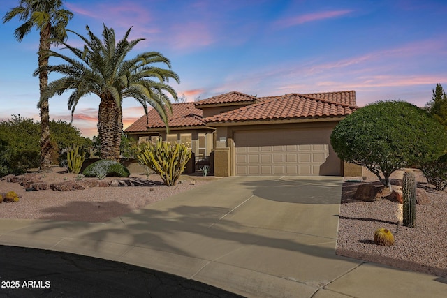 mediterranean / spanish-style house with a garage