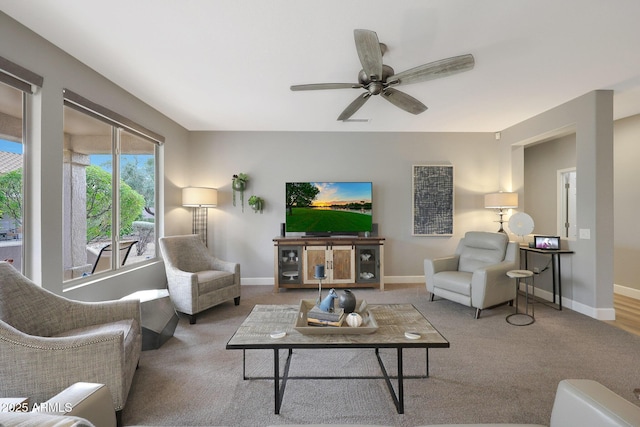 carpeted living room featuring ceiling fan