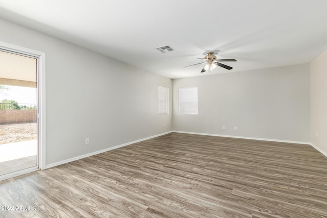 6537 W Riva Rd, Phoenix, AZ 85043 - empty room featuring ceiling fan, wood-type flooring, and plenty of natural light