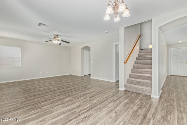 6537 W Riva Rd, Phoenix, AZ 85043 - unfurnished living room with ceiling fan with notable chandelier and light wood-type flooring