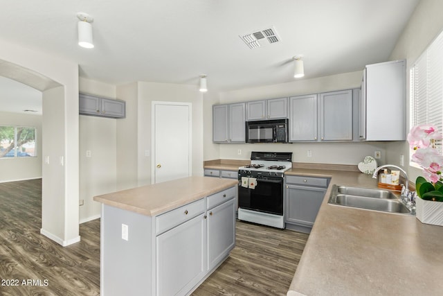 6537 W Riva Rd, Phoenix, AZ 85043 - kitchen with dark hardwood / wood-style floors, sink, gray cabinetry, a center island, and gas stove
