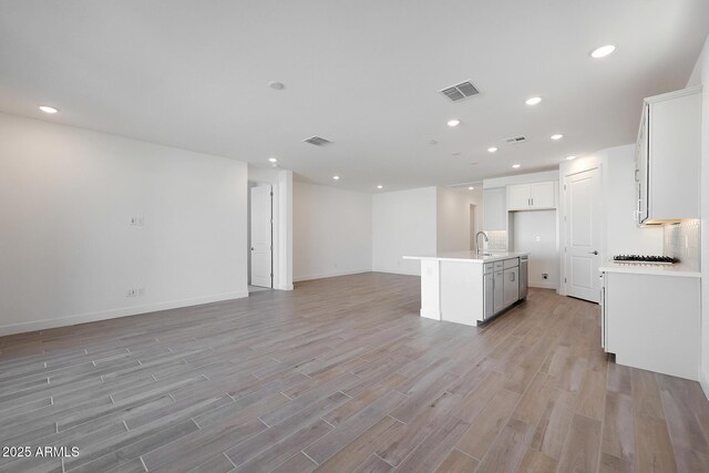 gym with ceiling fan, a high ceiling, and dark carpet