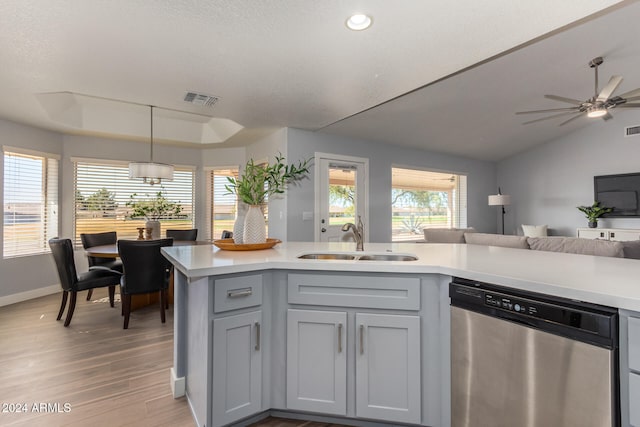 kitchen featuring stainless steel dishwasher, hanging light fixtures, sink, and a healthy amount of sunlight