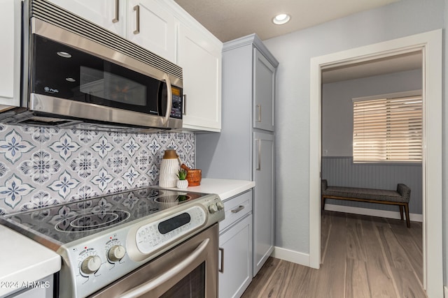 kitchen featuring white cabinets, light hardwood / wood-style floors, and stainless steel appliances