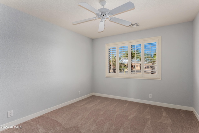 empty room featuring carpet flooring and ceiling fan