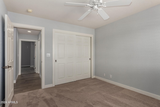 unfurnished bedroom featuring ceiling fan, carpet flooring, and a closet