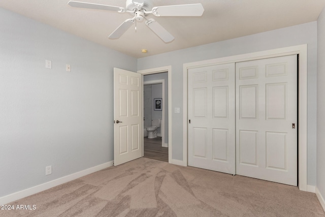 unfurnished bedroom with light colored carpet, ceiling fan, and a closet