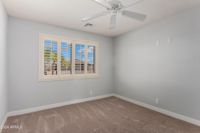 spare room with carpet floors and ceiling fan