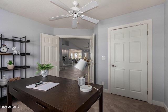 carpeted home office featuring ceiling fan