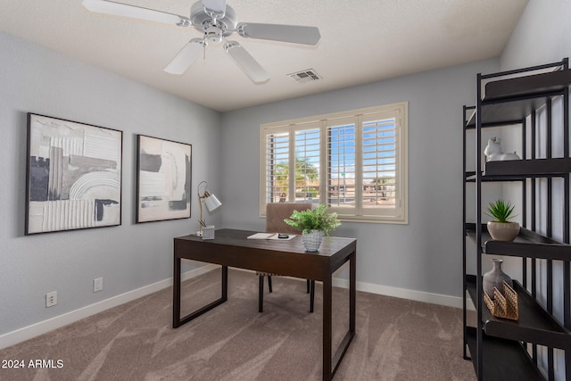 office featuring a textured ceiling, carpet, and ceiling fan