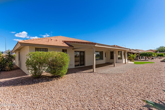 back of property with a patio