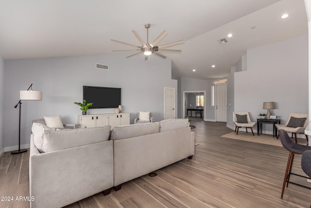 living room featuring hardwood / wood-style floors, ceiling fan, and high vaulted ceiling