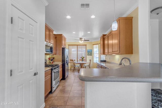 kitchen featuring kitchen peninsula, ceiling fan, light tile floors, stainless steel appliances, and decorative light fixtures